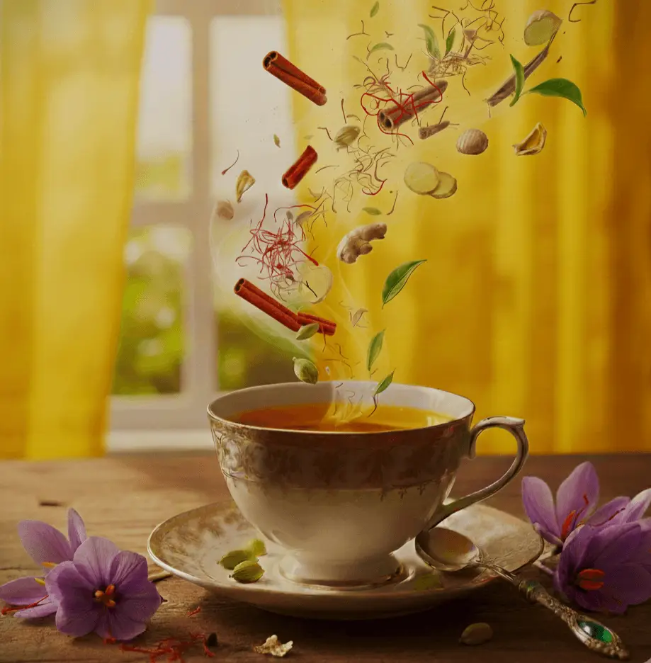 Cinnamon and spices falling into a steaming cup of tea